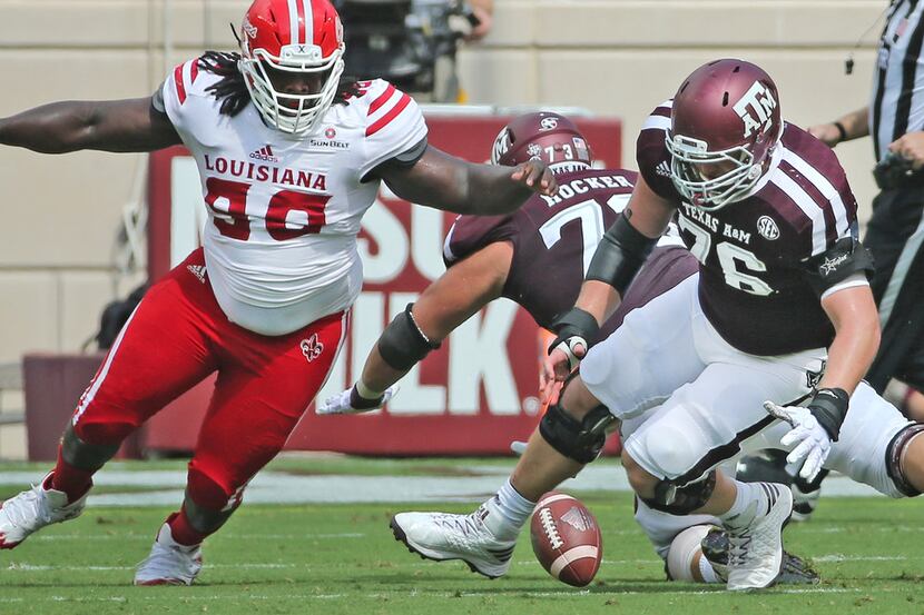 FILE - Louisiana-Lafayette defensive tackle Kevon Perry (90) and Texas A&M offensive lineman...