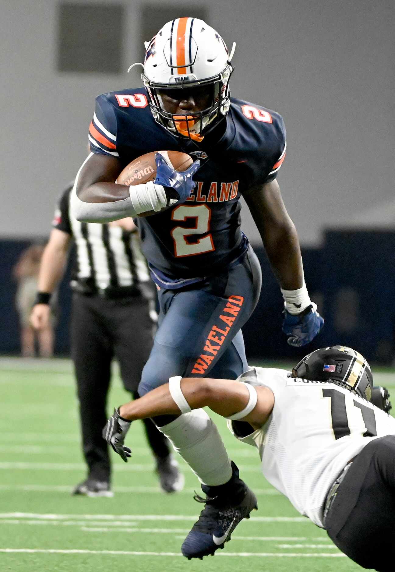 Frisco Wakeland's Jared White (2) runs through a tackle attempt by The Colony's Madaven...