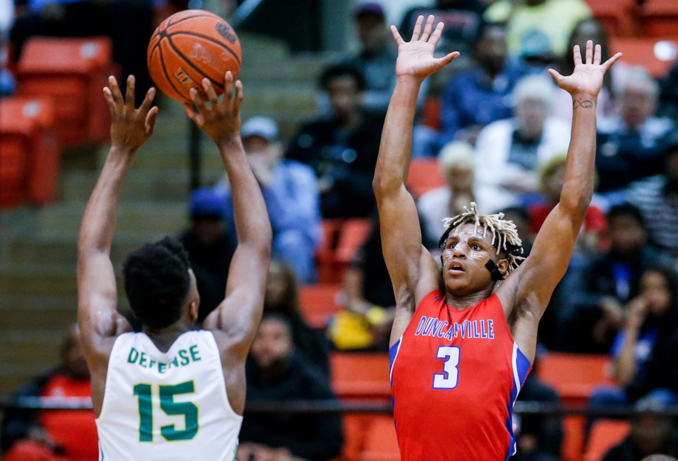 DeSoto senior guard Claven Wilson (15) attempts a shot as Duncanville senior guard Jahmi'us...