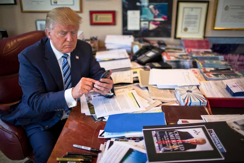FILE-- Donald Trump demonstrates his tweeting skills in his office at Trump Tower in New...