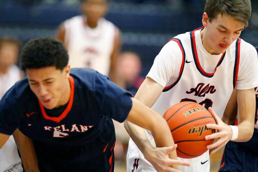 Allen forward Jake Herrin (20) wrestles a rebound from Wakeland forward Devin Roland (5)...