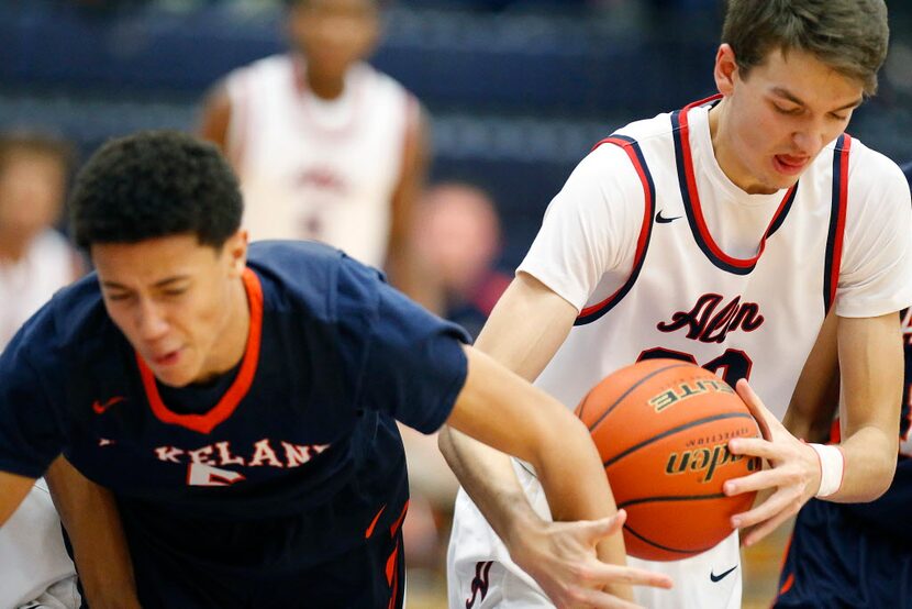 Allen forward Jake Herrin (20) wrestles a rebound from Wakeland forward Devin Roland (5)...