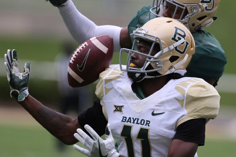 Baylor wide receiver Pooh Stricklin (11) attempts a catch as safety Jourdan Blake (23)...