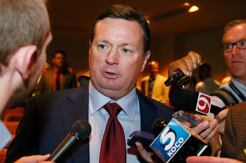Bob Stoops, former head football coach, is interviewed by the media following the...