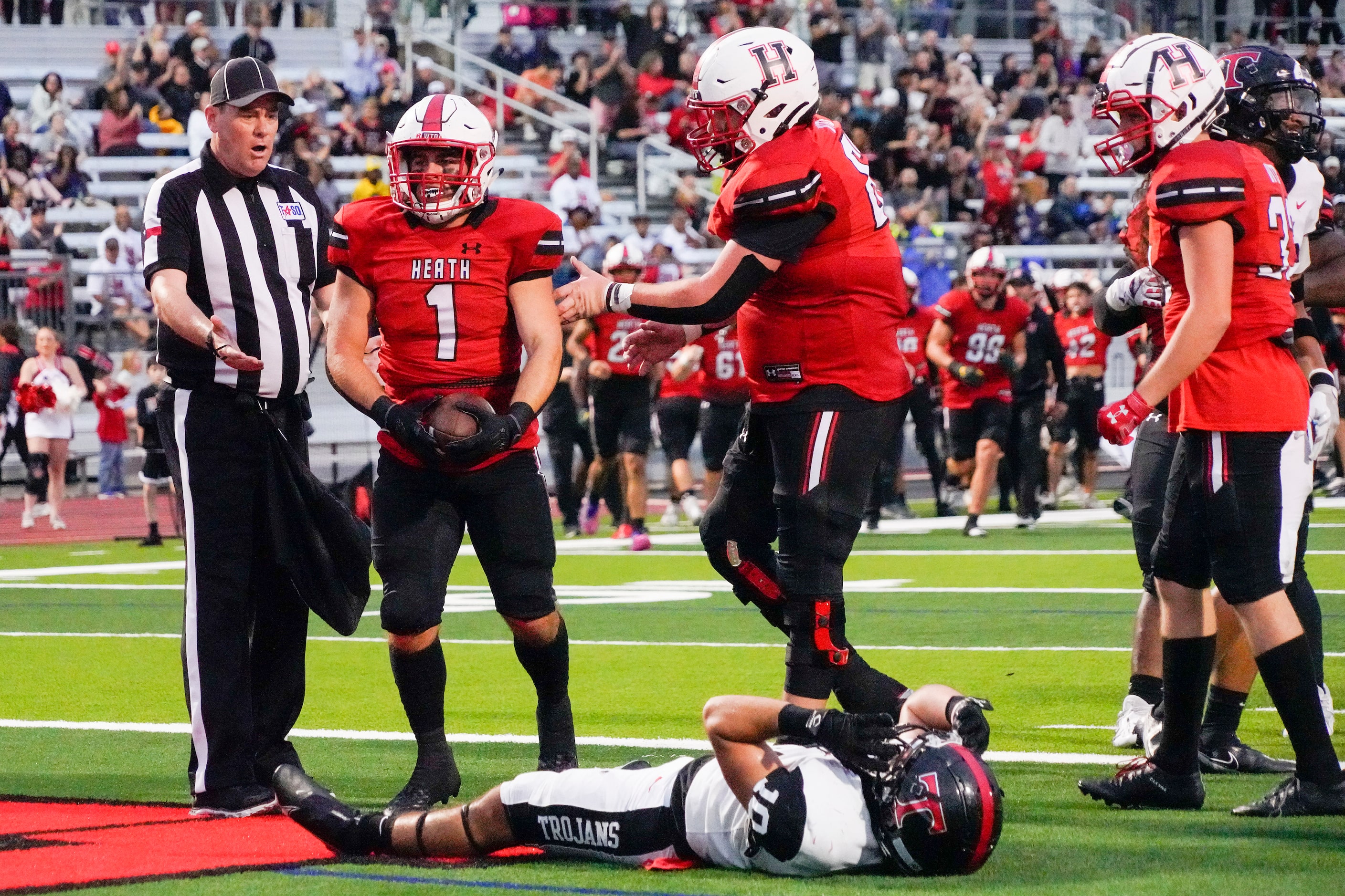 Rockwall-Heath running back Brittan Snider (1) celebrates after scoring on a 1-yard...