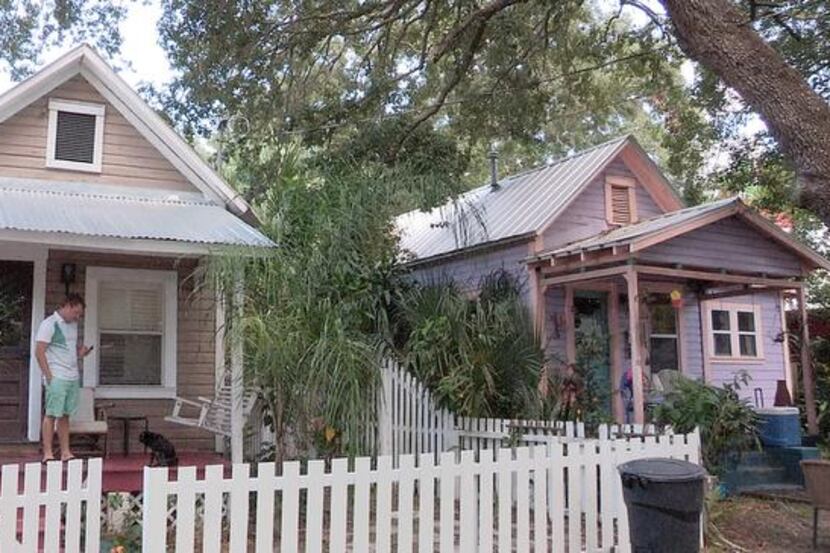 
Matthew Clarie checks his email on the porch of the 388-square-foot home he rents in Hyde...