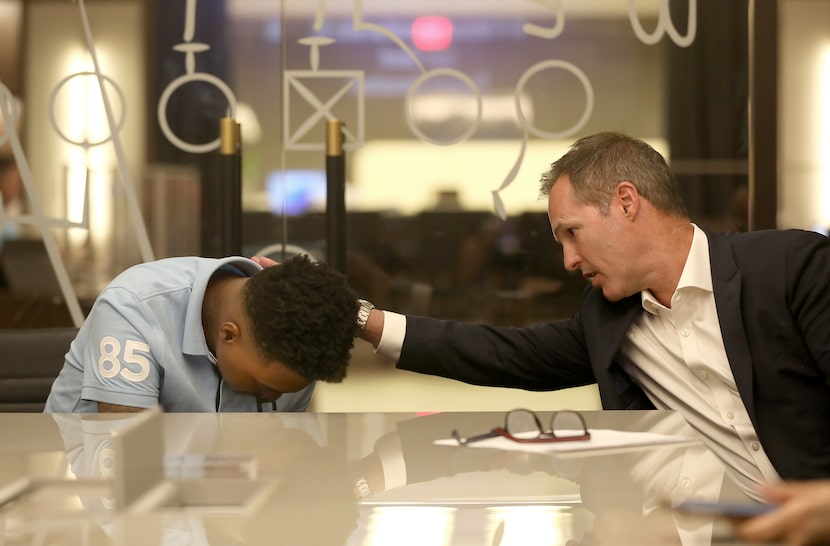 Tomiya Crenshaw, left, is comforted by his lawyer Paul Grinke, during an emotional interview...