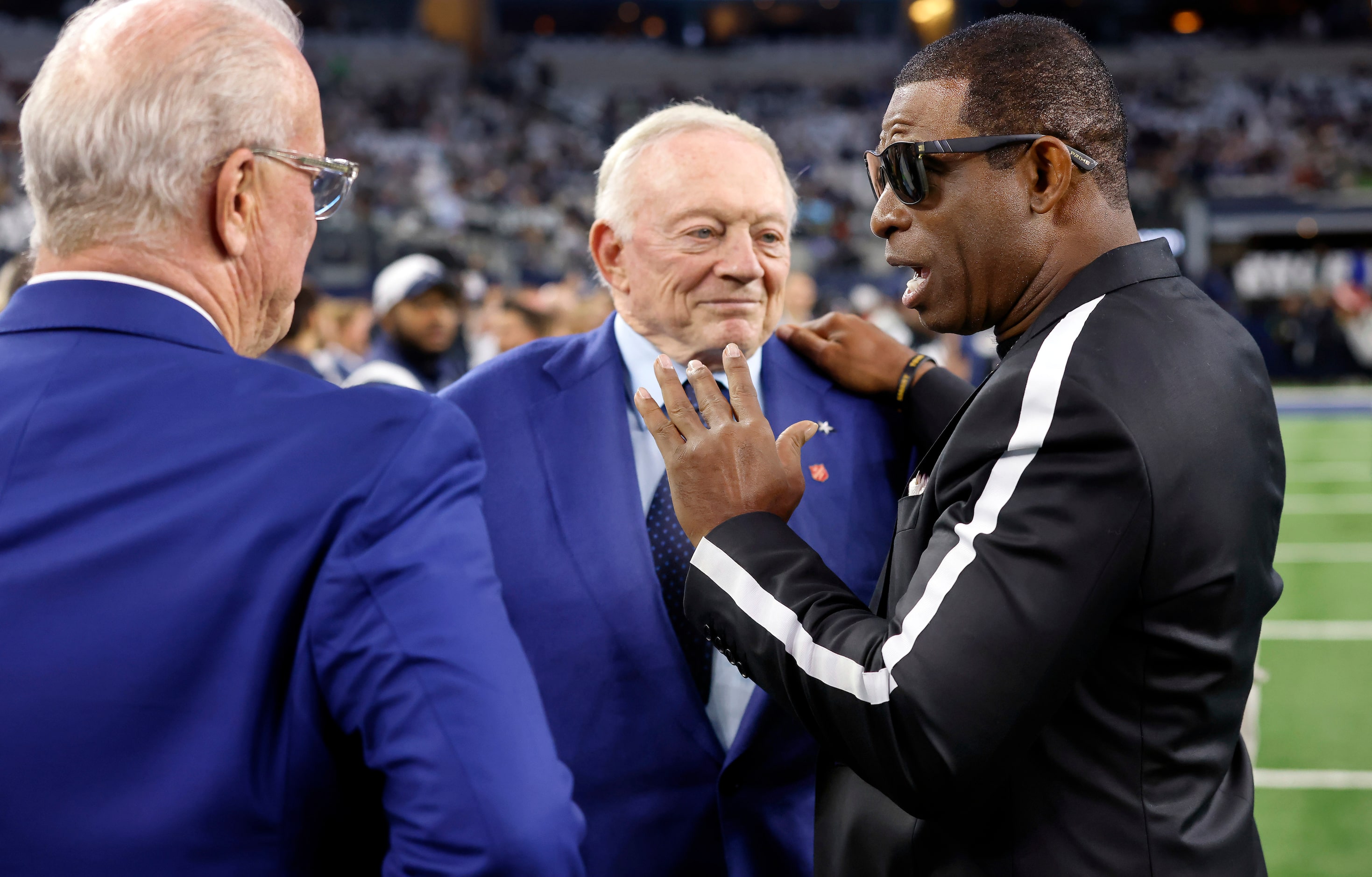 Former Dallas Cowboys player and current University of Colorado coach Deion Sanders (right)...