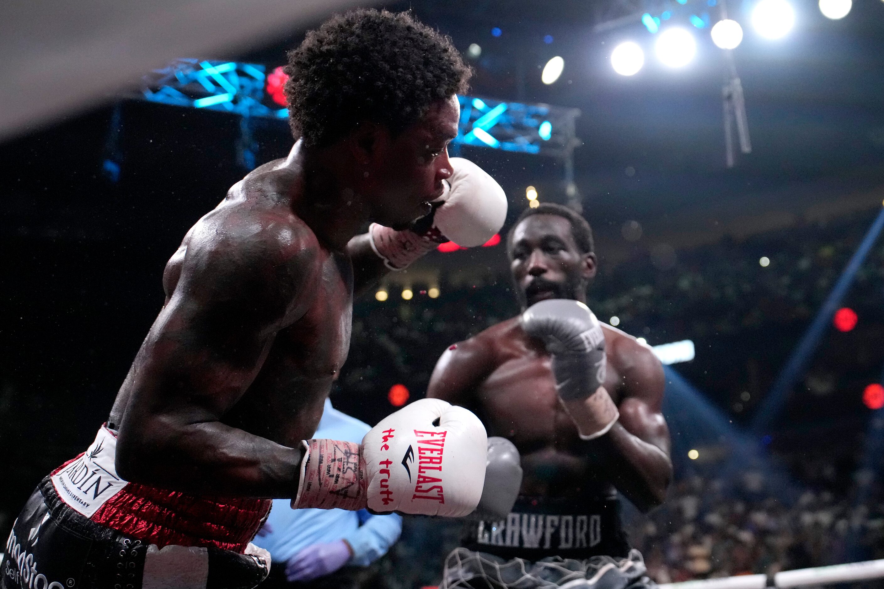 Errol Spence Jr., right, is knocked down by Terence Crawford, right, during their...