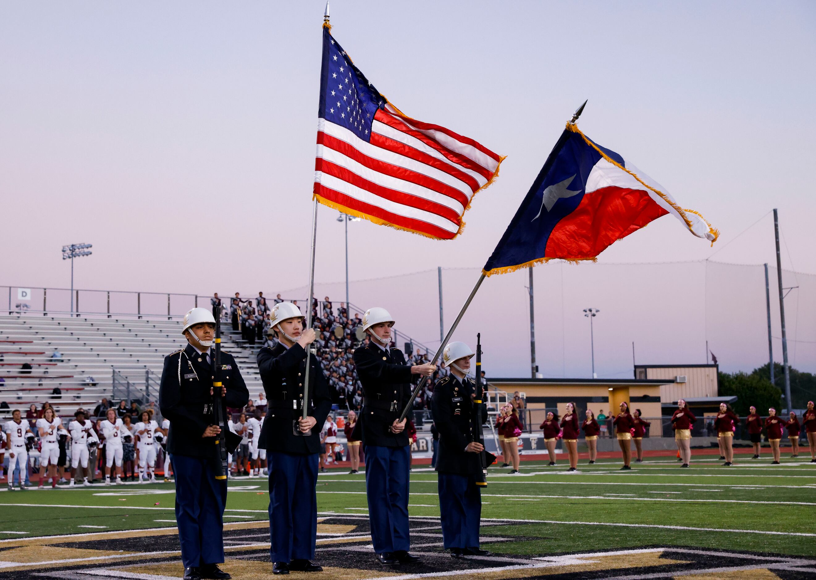 The Colony High School JROTC cadets hold the flags before the start of a District 5-5A...