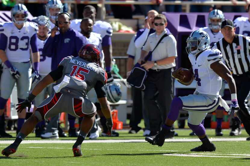 Quarterback Daniel Sams of the Kansas State Wildcats tries to get by Keenon Ward of the...