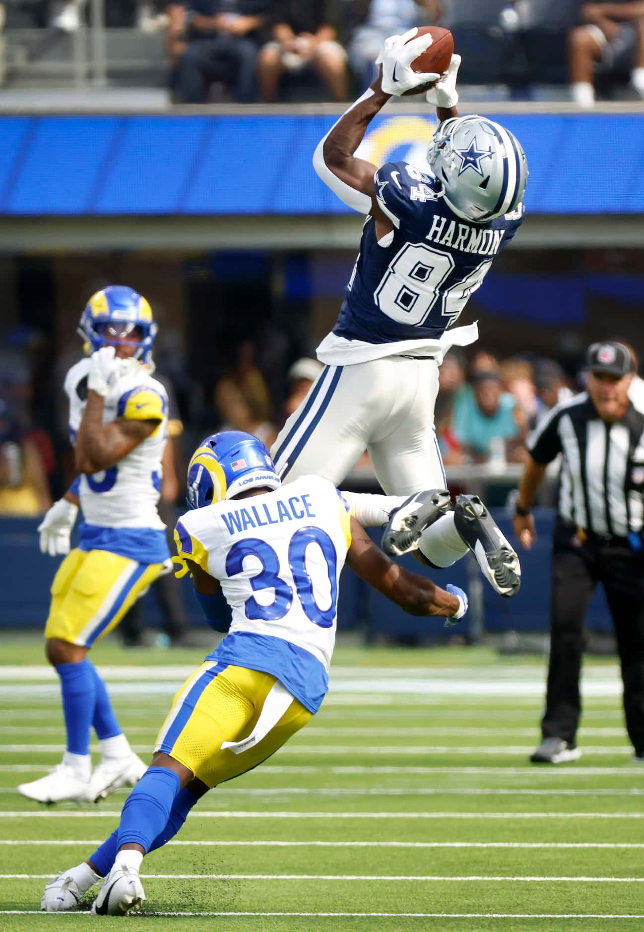 Dallas Cowboys wide receiver Kelvin Harmon (84) leaps to catch a pass as he was upended by...