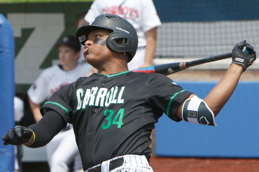 Southlake Carroll's Yanquis Ortiz (34) watches as he connects to drive a pitch toward the...