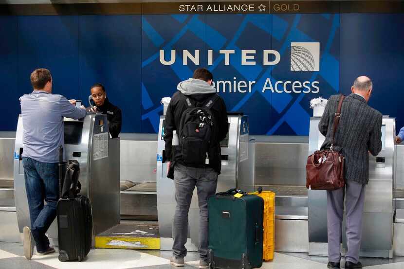 Travelers check-in at the United Airlines Premier Access at O'Hare International Airport on...