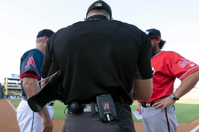 Minor League Baseball home plate umpire Kelvis Velez, wearing a wireless receiver and ear...
