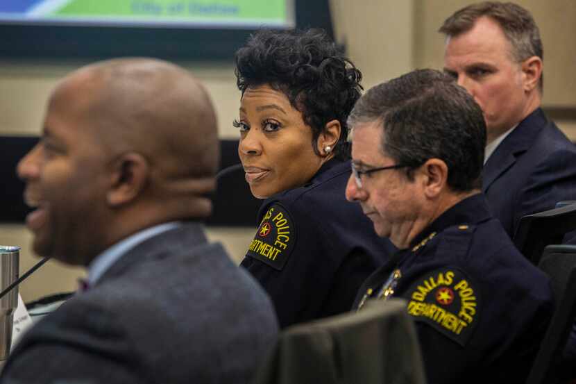 Chief U. Renee Hall, of the Dallas Police Department, center, listens to Dr. Brian Williams,...