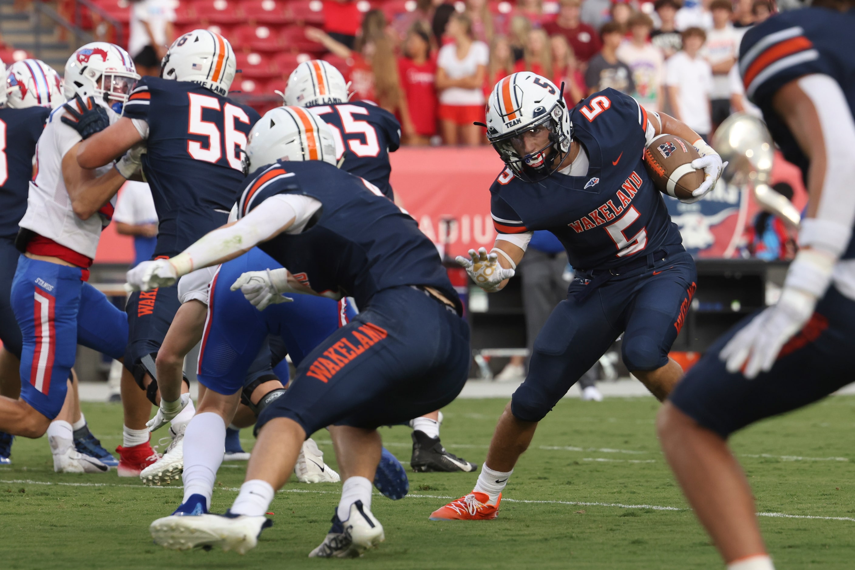 Wakeland High School’s  Ashdyn Kahouch (5) carries the ball up the field during the first...