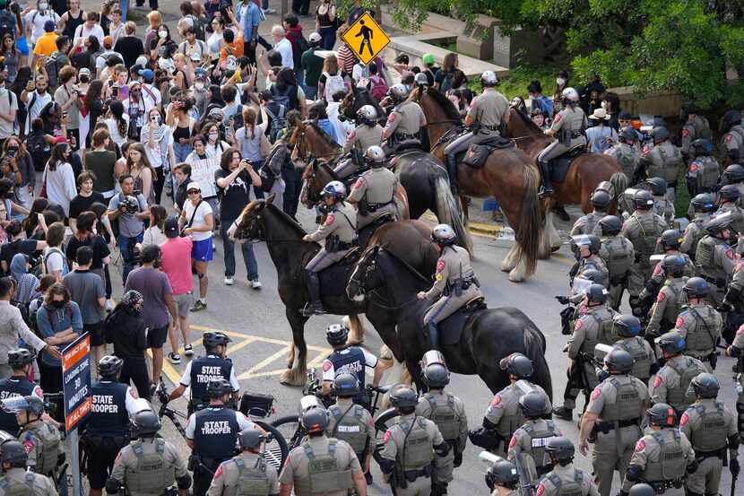 State troopers try to break up a protest at the University of Texas Wednesday on Wednesday...