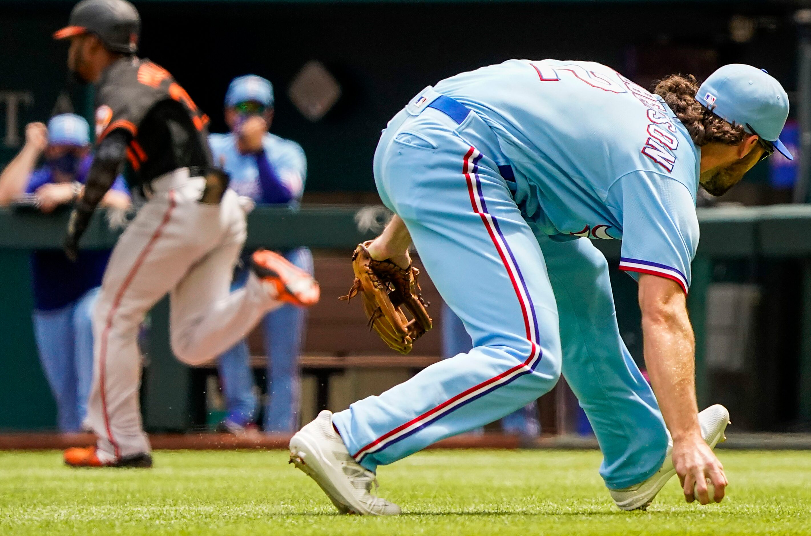 Texas Rangers third baseman Charlie Culberson makes a barehanded play on soft grounder by...