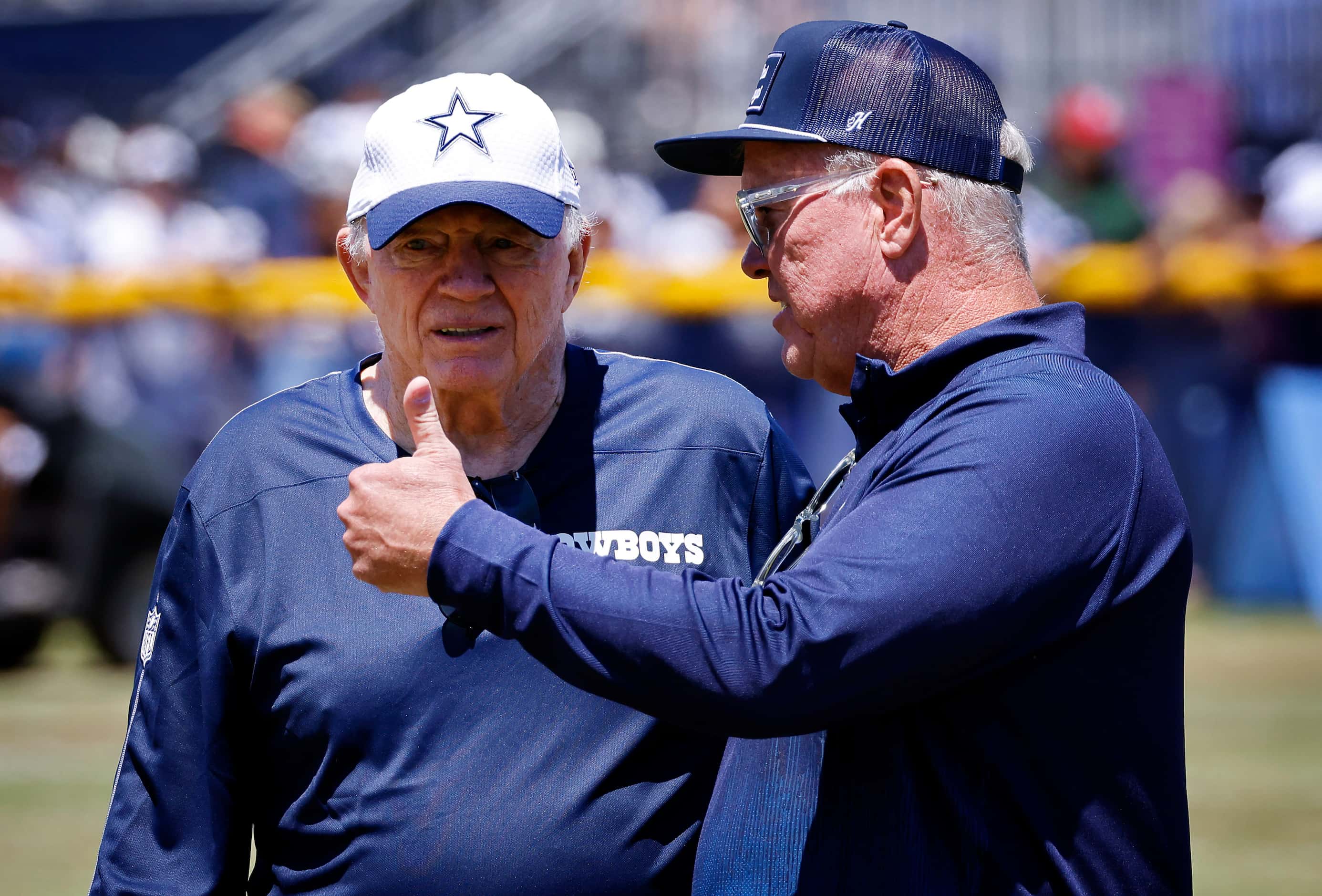 Dallas Cowboys owner Jerry Jones (left) and son Stephen Jones visit on the sideline...