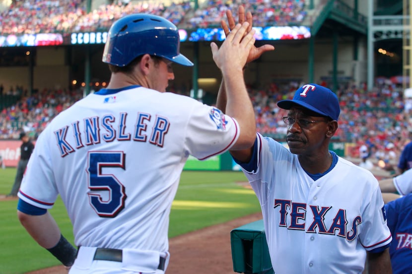 Texas Rangers second baseman Ian Kinsler (5) is congratulated  by  manager Ron Washington...