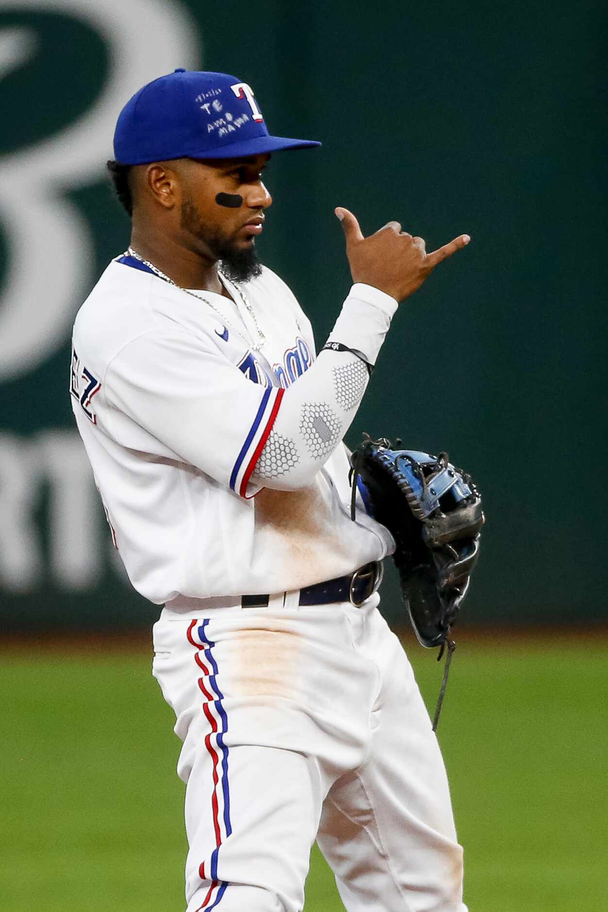 Texas Rangers second baseman Yonny Hernandez (65) signals to a teammate during the third...