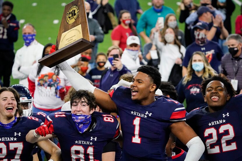 Denton Ryan wide receiver Ja'Tavion Sanders (1) lifts the championship trophy as the Raiders...