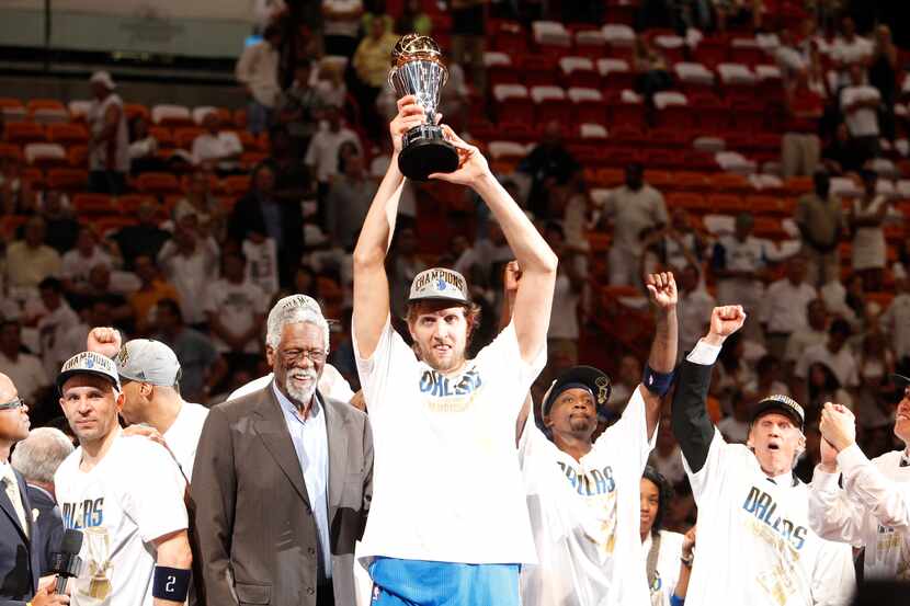 Dallas Mavericks power forward Dirk Nowitzki (41) hoists the Bill Russell NBA Finals MVP...