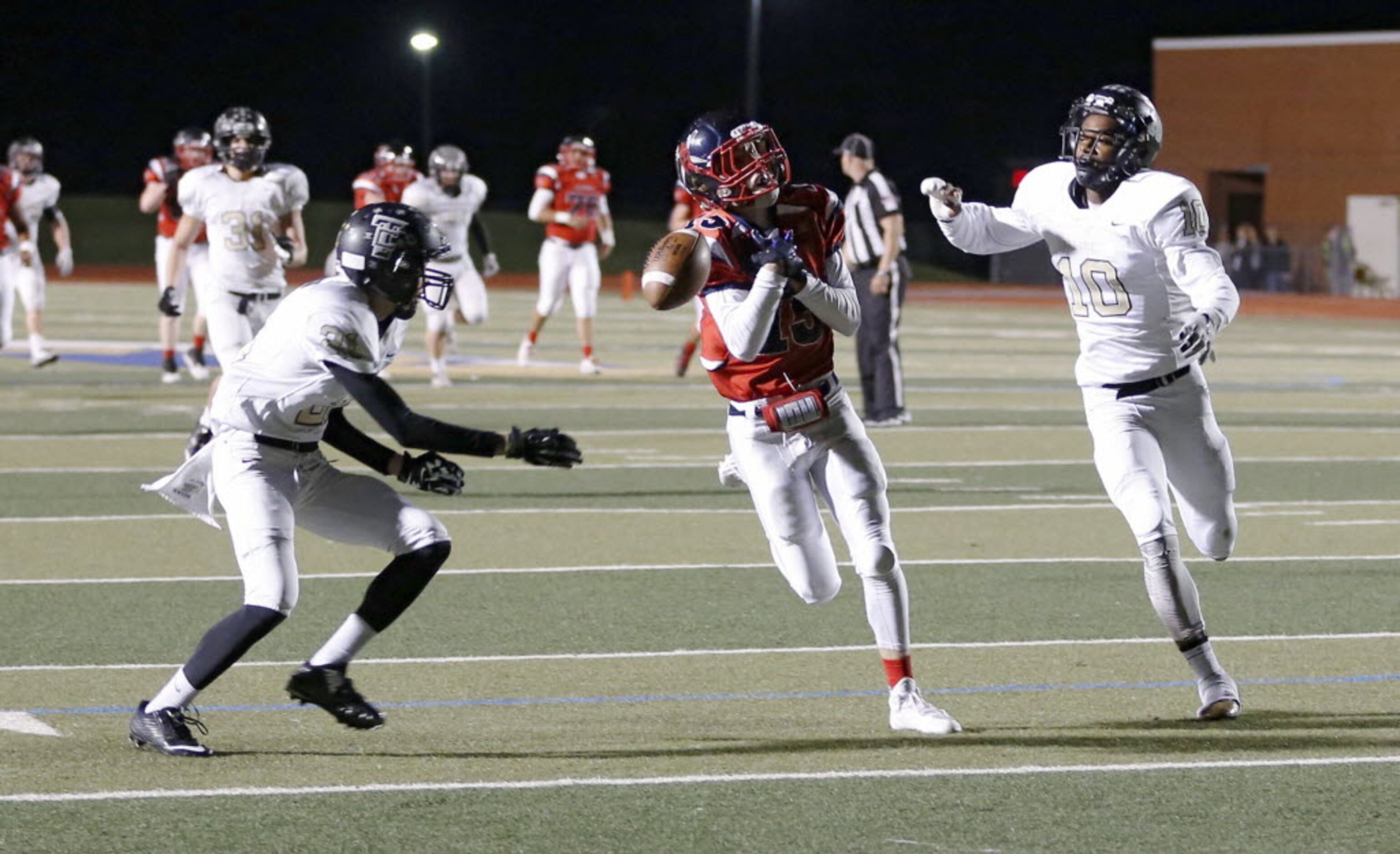 Frisco Centennial's Adam Hoffman (15) can't make the catch as The Colony's Jalen Brown (21)...