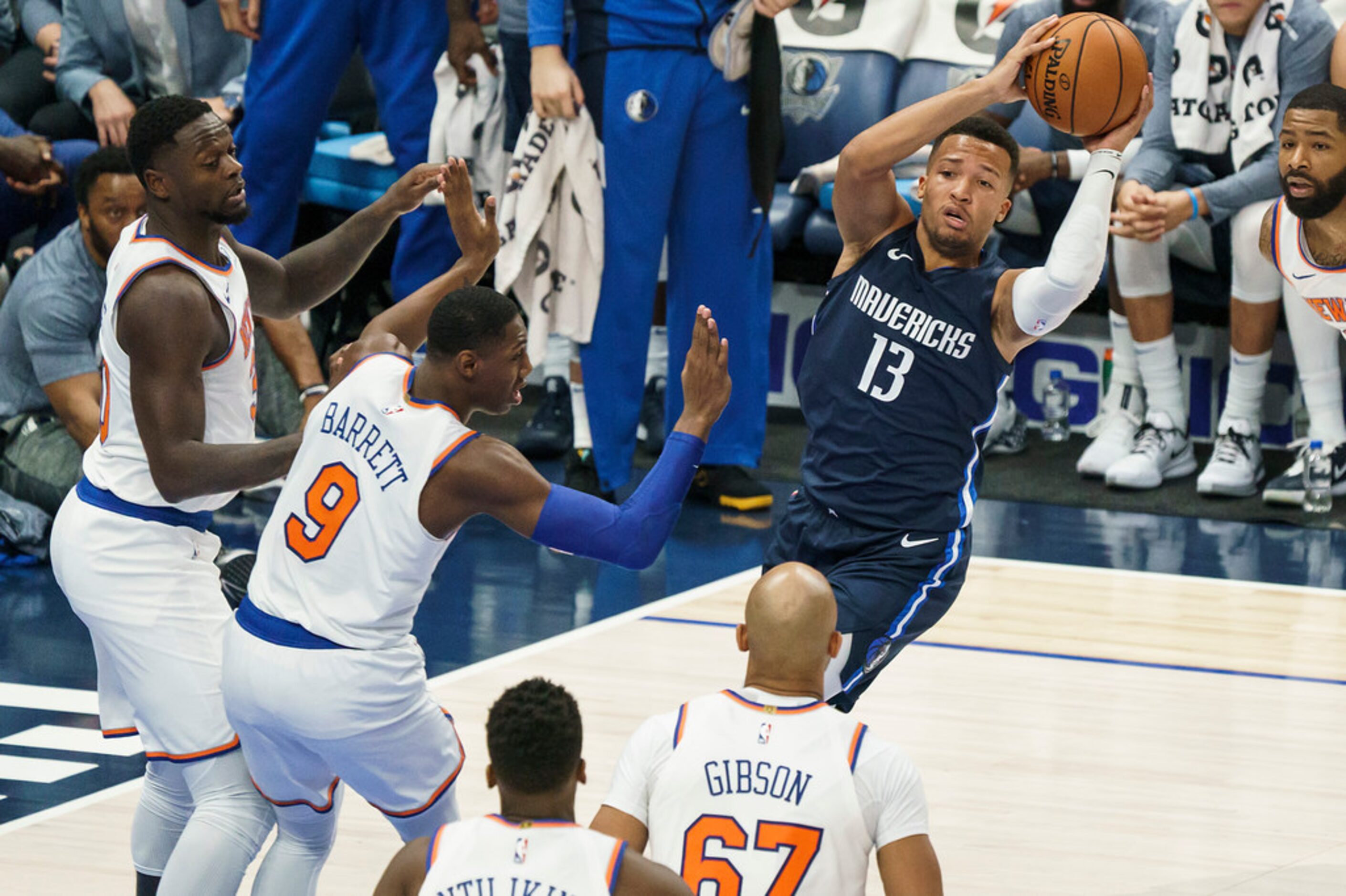 Dallas Mavericks guard Jalen Brunson (13) looks to pass around New York Knicks guard RJ...