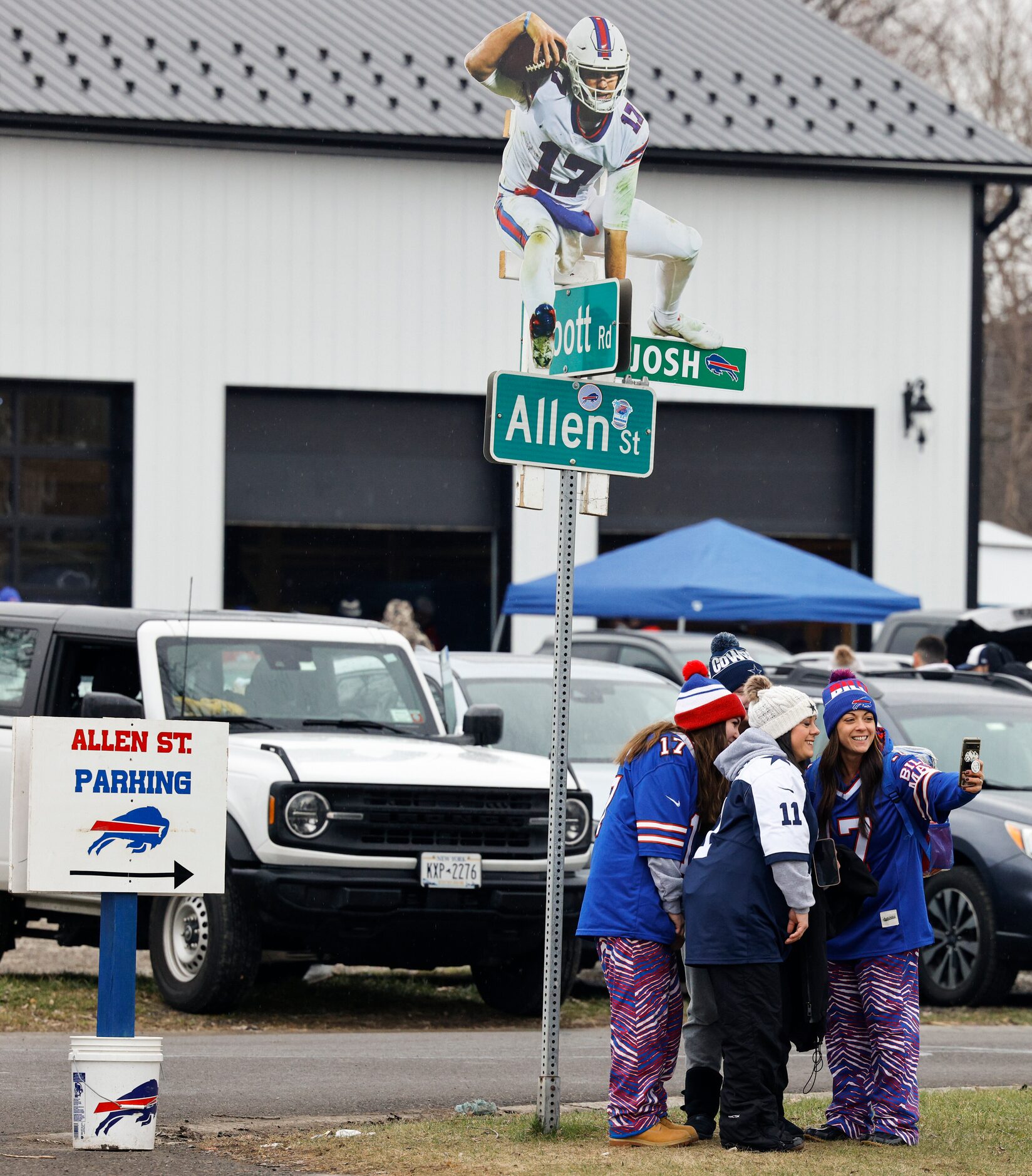 Dallas Cowboys and Buffalo Bills fans pose for a photo with a Buffalo Bills quarterback Josh...