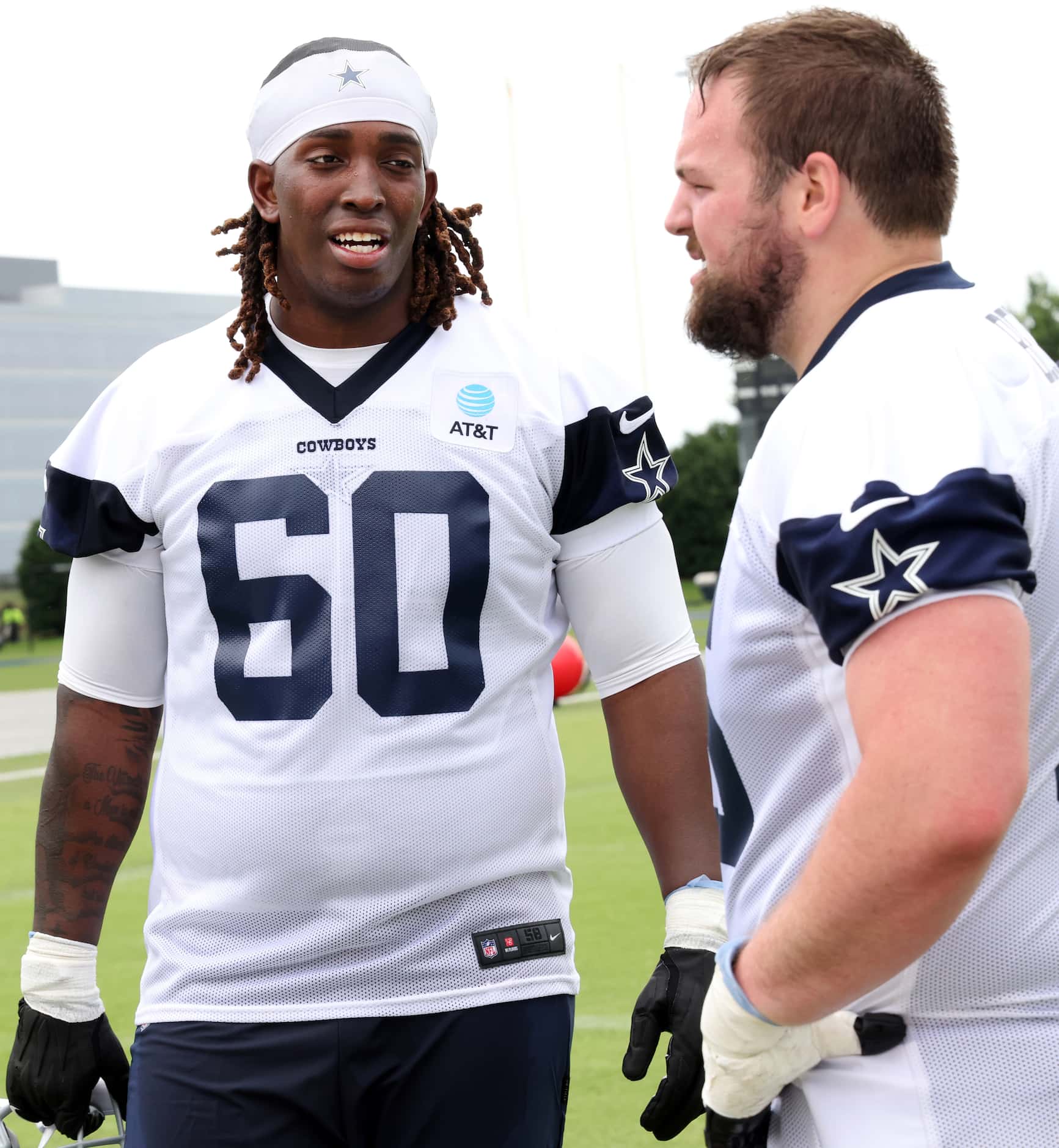 Dallas Cowboys offensive linemen Tyler Guyton (60) and Cooper Beebe (56) share thoughts...