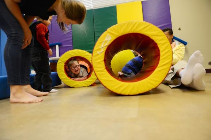 
Perrin Koons, speech language pathologist, peeks down at Ben Woodard during the Bridge...