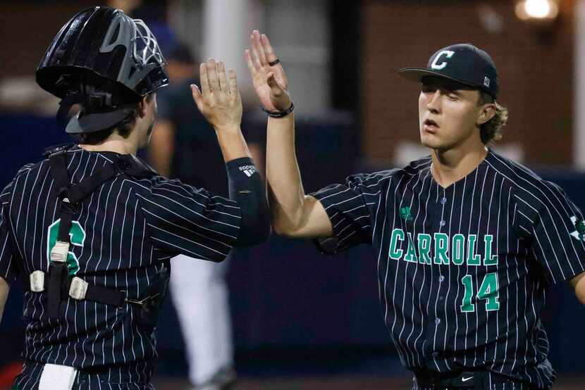 Southlake Carroll’s Griffin Herring, right, and Clark Springs hi5s during the sixth inning...