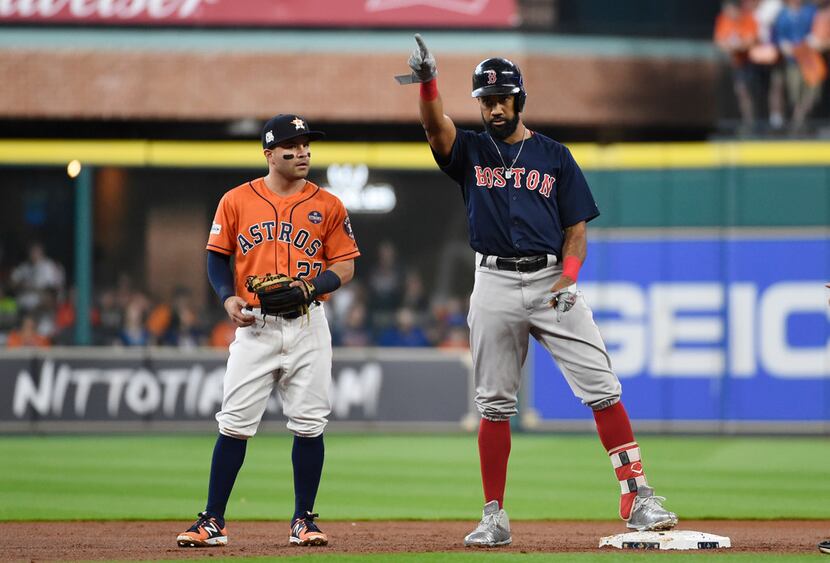 Boston Red Sox's Chris Young, right, points to teammates after he hit a double against the...