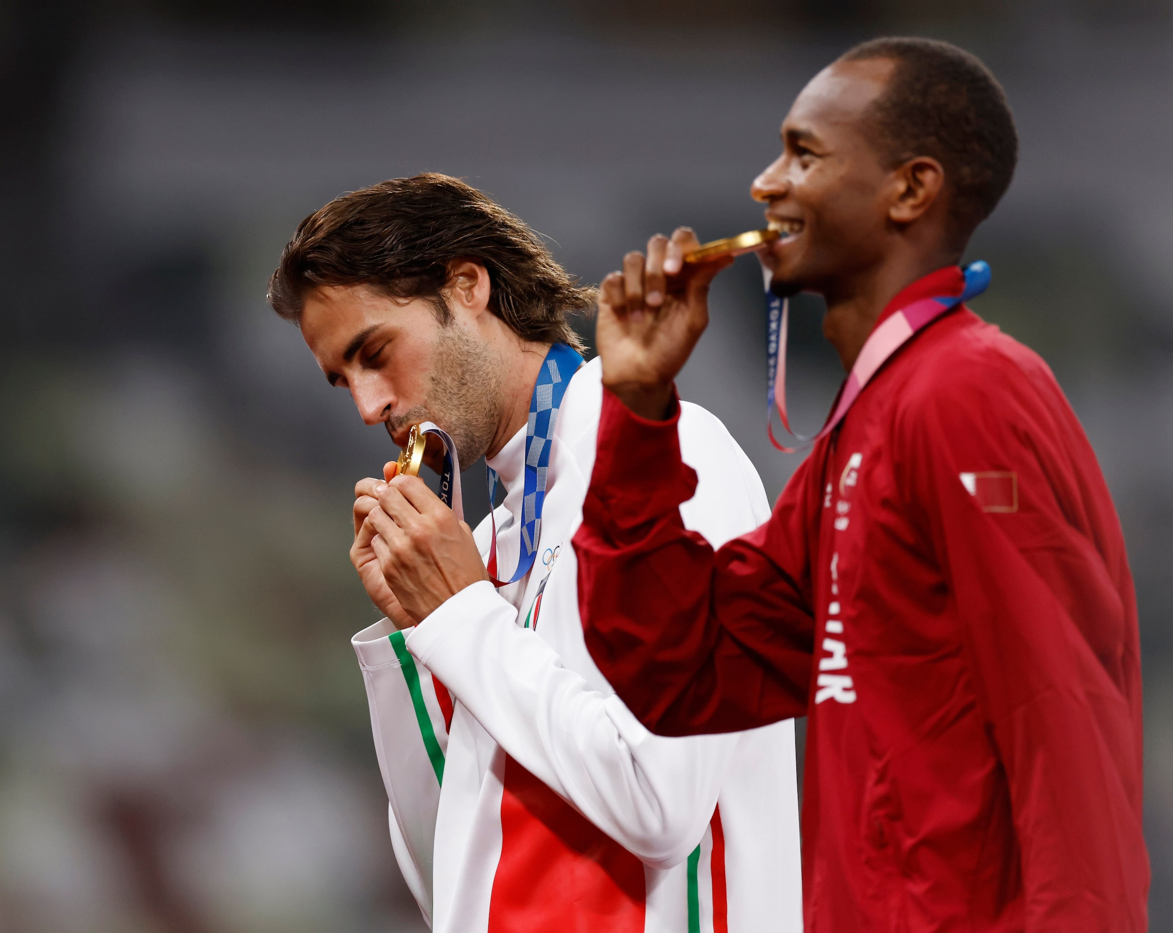 Italy’s Gianmarco Tamberi and Qatar’s Mutaz Essa Barshim pose for photos after receiving...