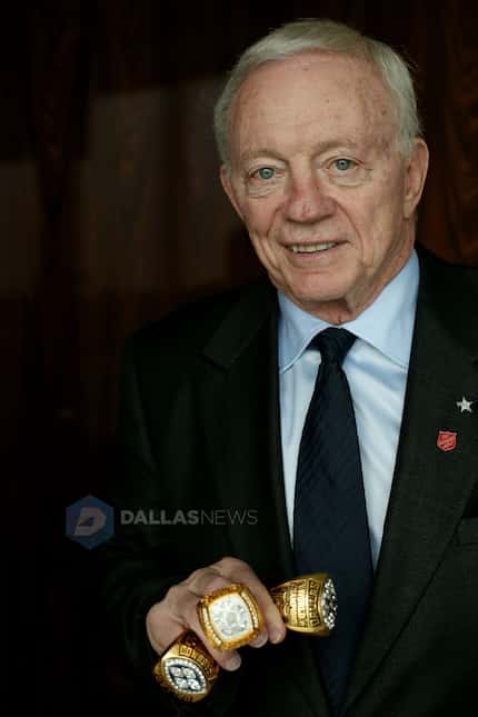 Jerry Jones holds display replica versions of the three Super Bowl rings the Dallas Cowboys...