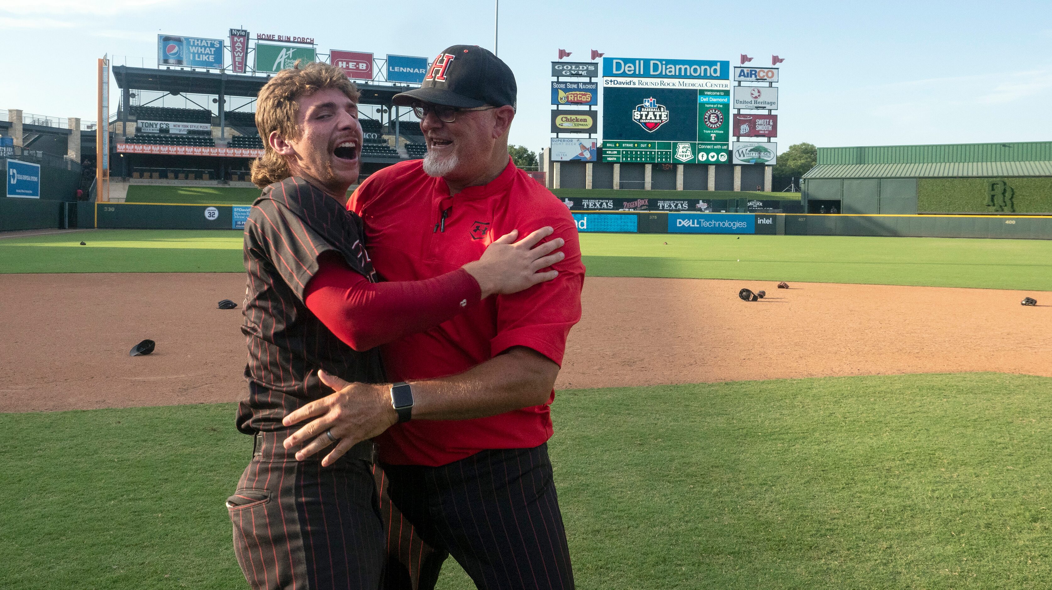 Rockwall-Heath head coach, Greg Harvey, celebrates with Karson Krowka, (5), after defeating...