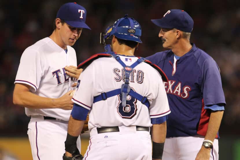 Texas Rangers pitching coach Mike Maddux (31) talks with Texas Rangers starting pitcher Nick...