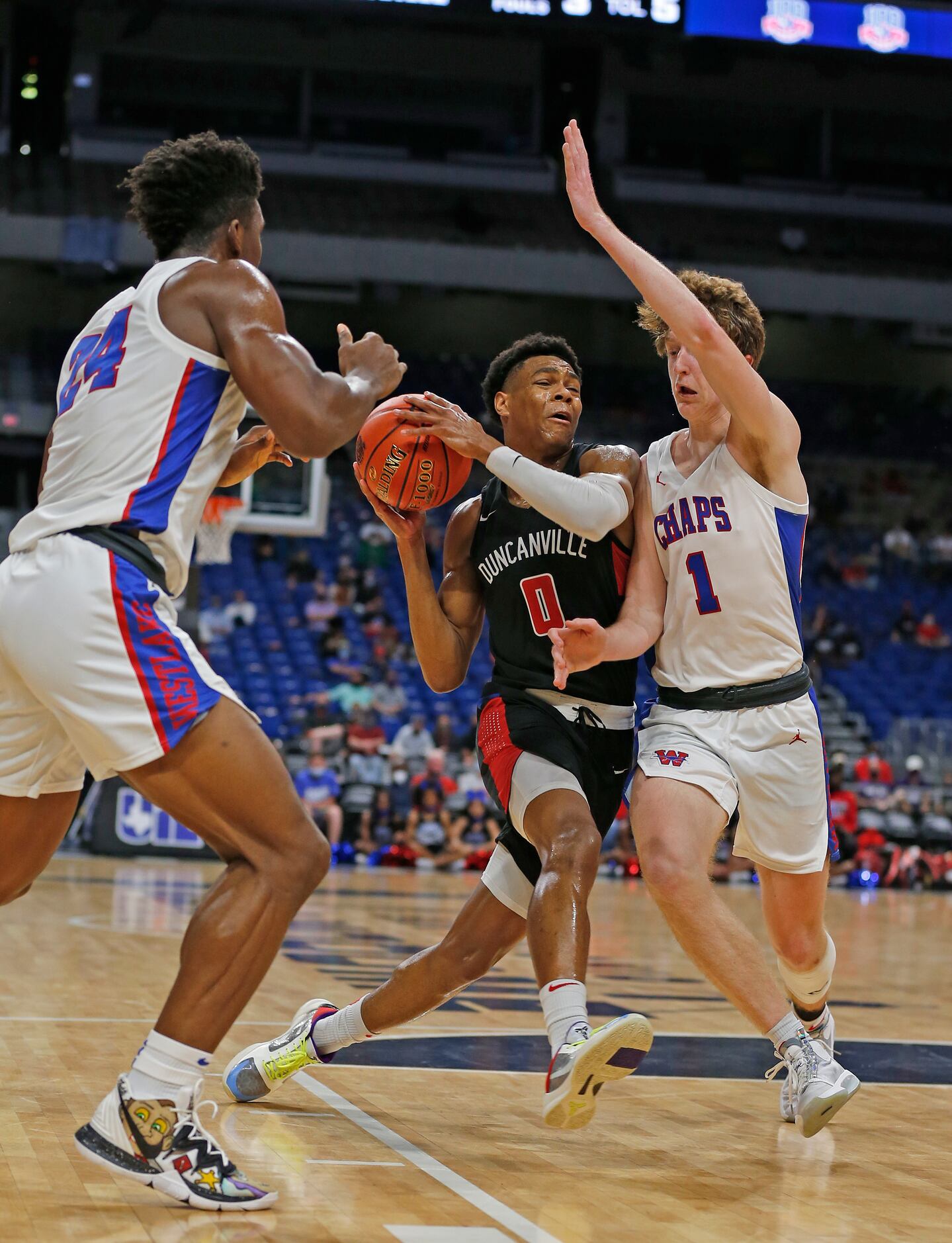 Duncanville Zhuric Phelps #0 drives on Westlake Cade Mankle #1. UIL boys Class 6A basketball...