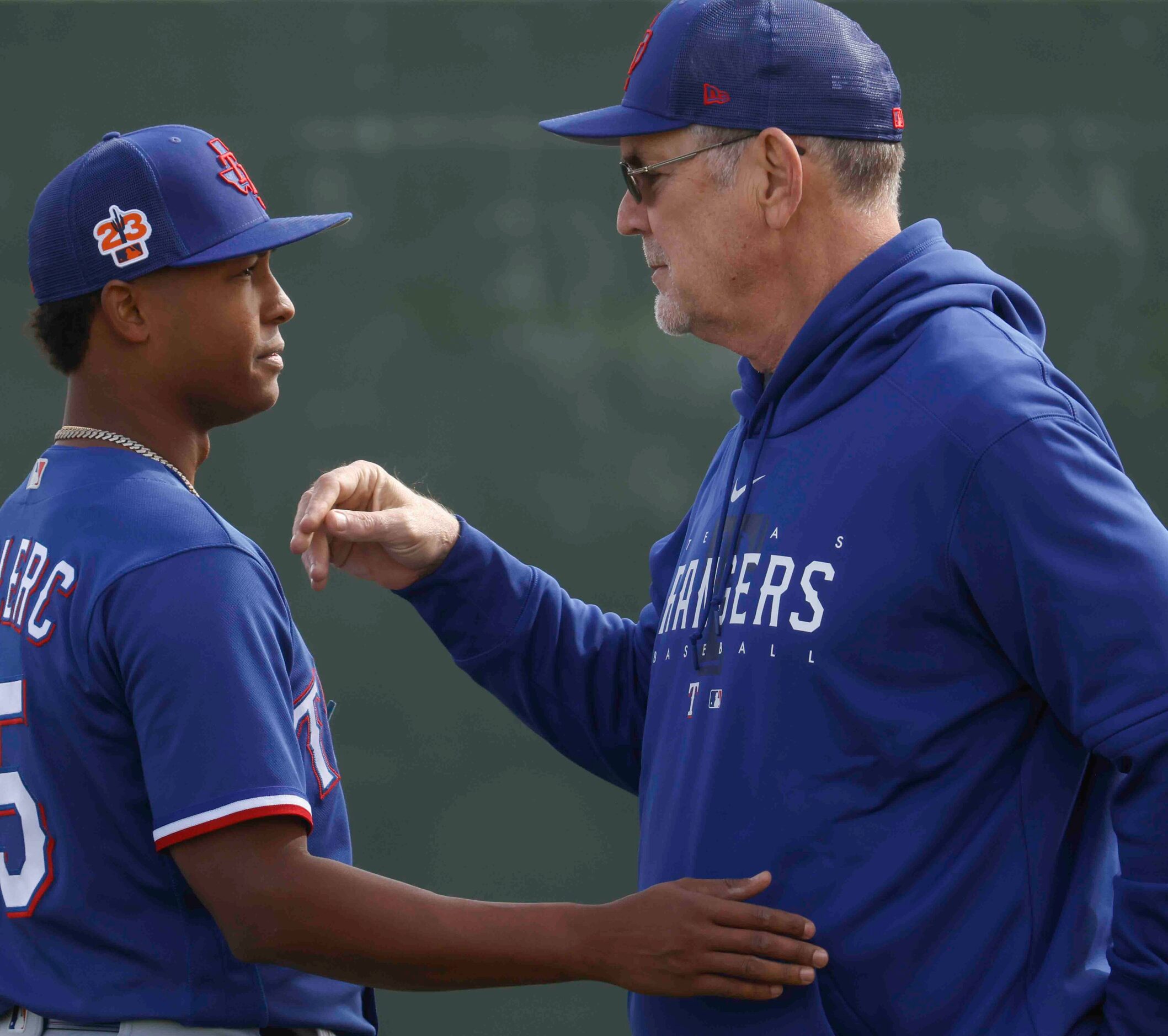 Texas Rangers pitcher Jose Leclerc, left, interacts with manager Bruce Bochy during a spring...