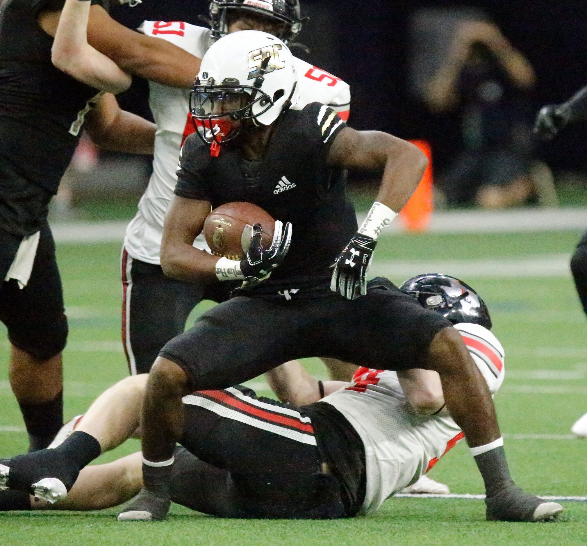 South Oak Cliff High School wide receiver Randy Reece (5) is brought down by Lovejoy High...