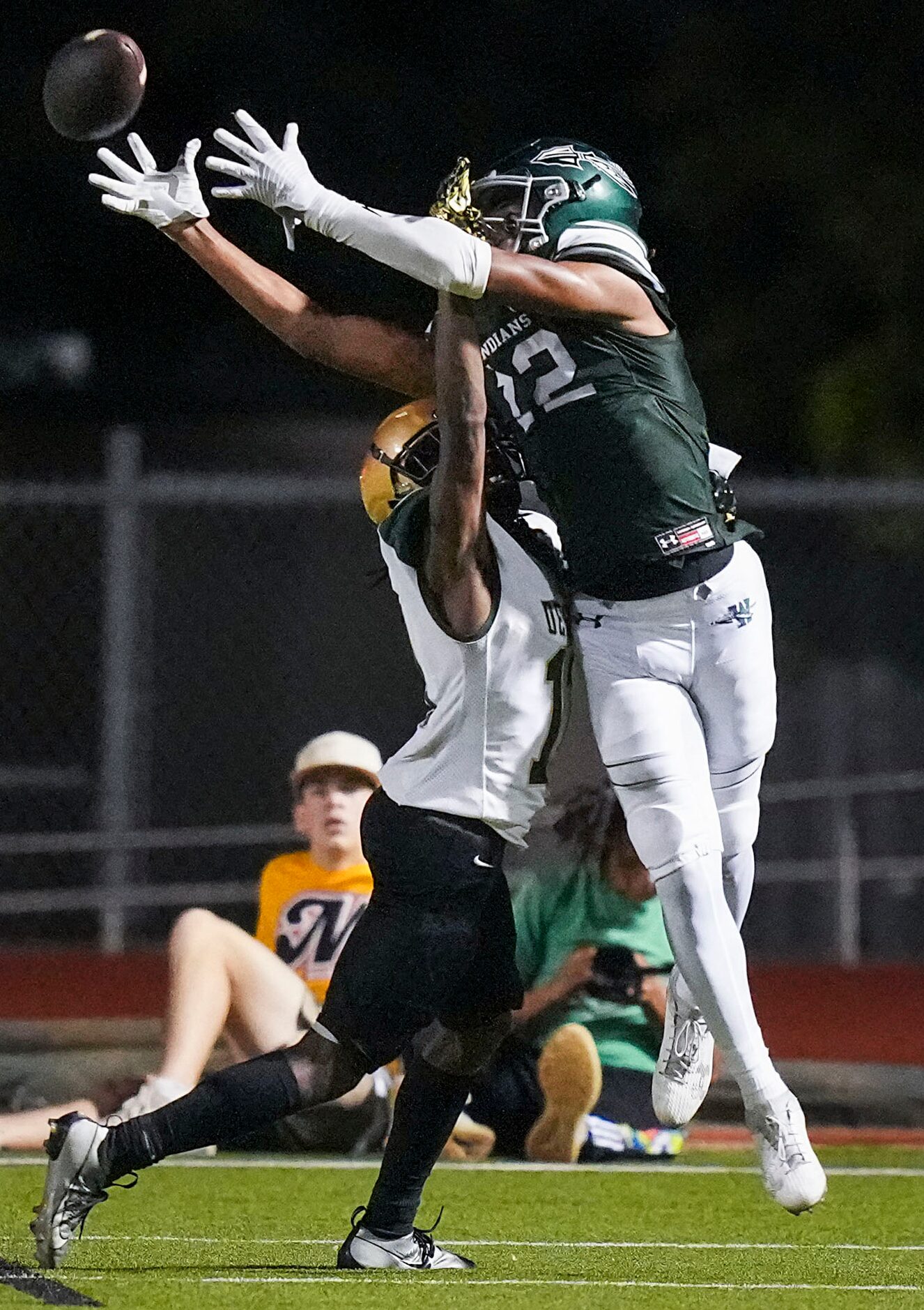 Waxahachie wide receiver Michael Esparza Jr. (12) tips the ball up and comes down with a...