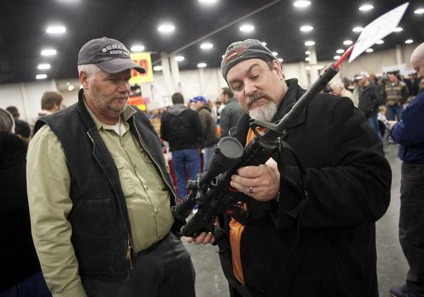 Gun owners discussed a potential sale of an AR-15 during the 2013 Rocky Mountain Gun Show at...