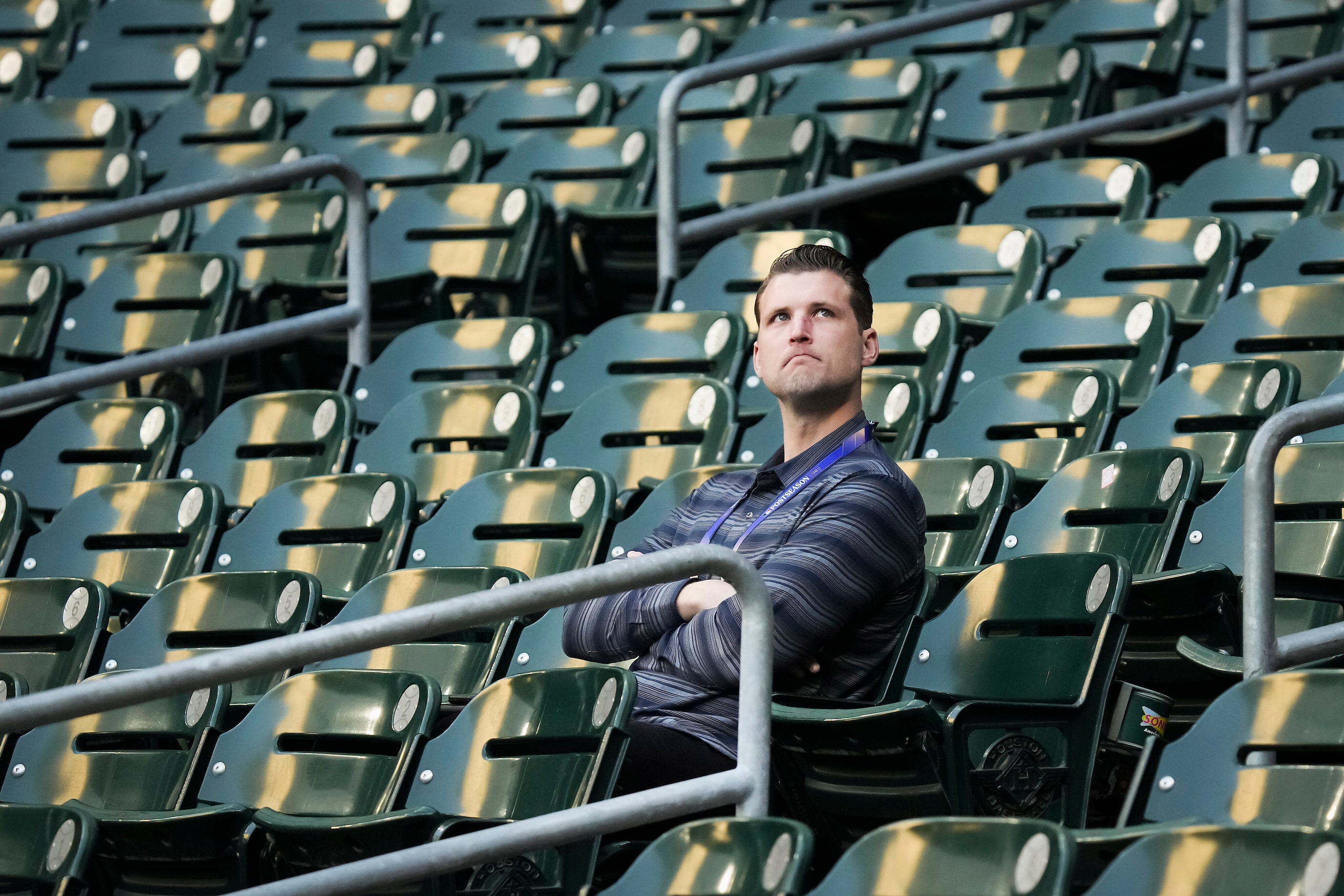 Texas Rangers assistant general manager Ross Fenstermaker watches from the stands during a...