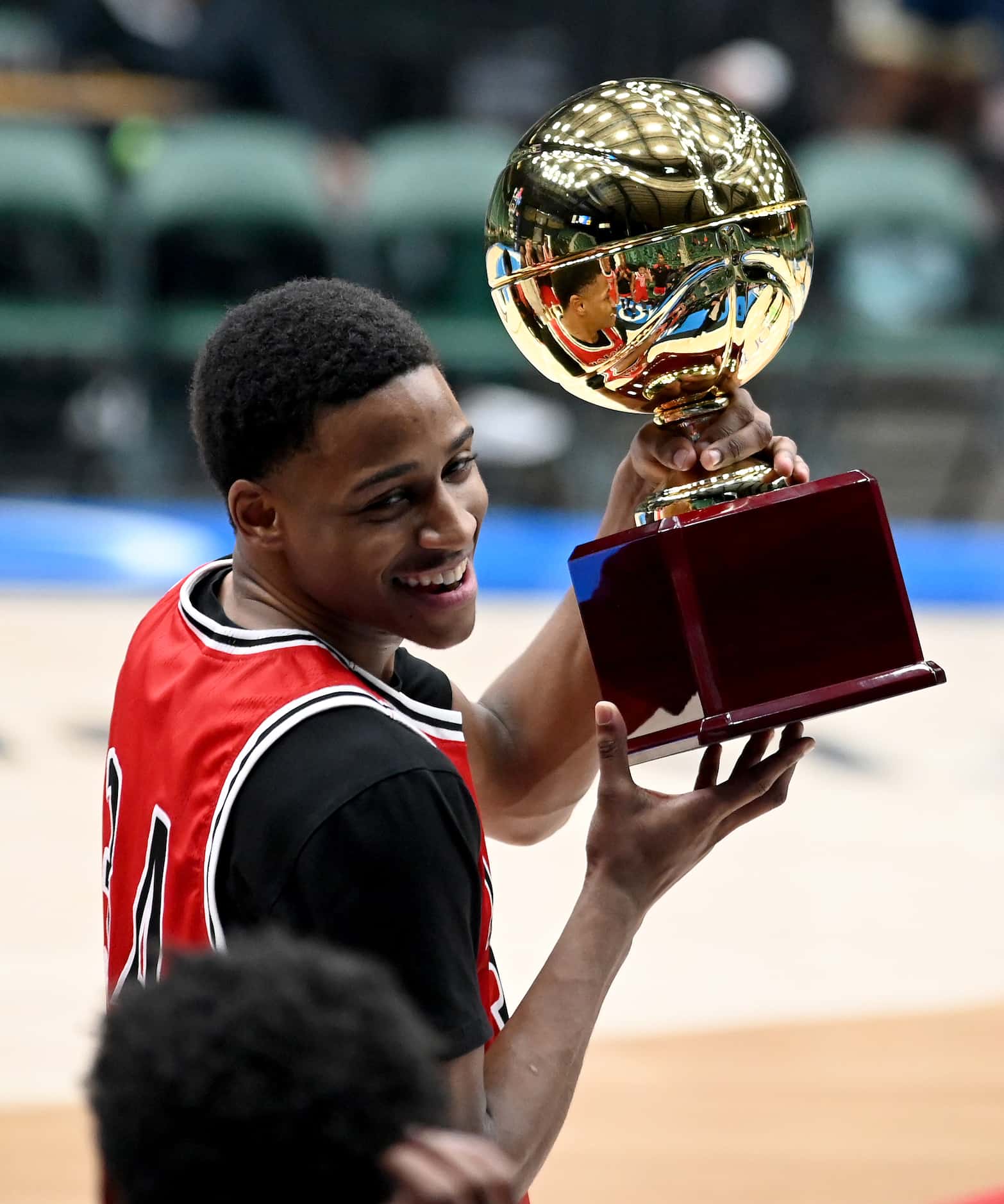 Mansfield Legacy’s Jaxon Miles holds up the championship trophy after Silver championship of...
