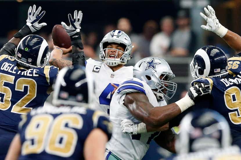 Dallas Cowboys quarterback Dak Prescott (4) releases a last second pass as he throws over...
