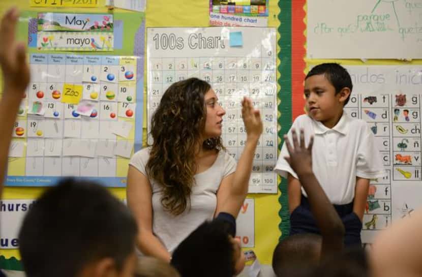 
Rodríguez asks kindergartener Jaime Torres questions in Spanish during class. On Mondays,...