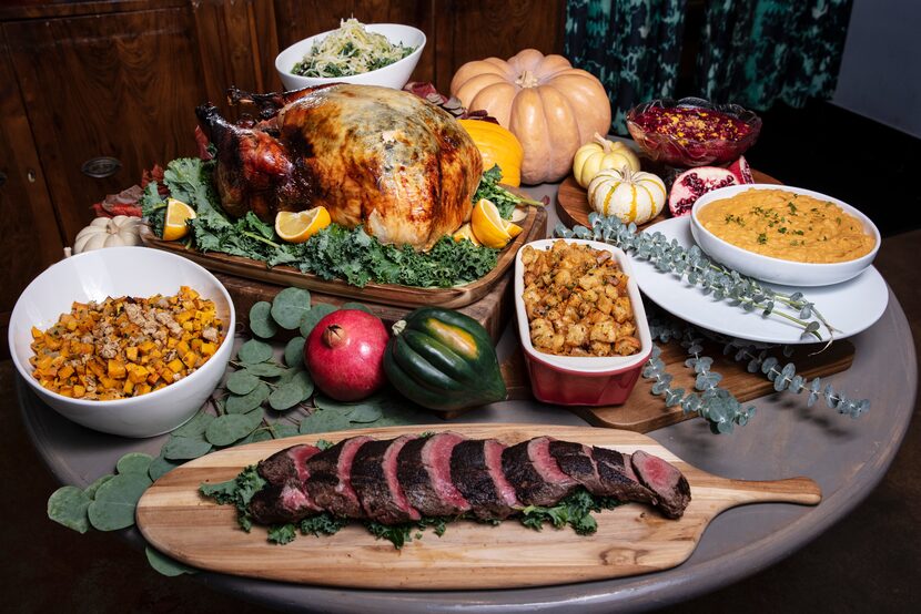 Herbed and brined turkey, seasoned and seared grass-fed beef tenderloin and sides are...