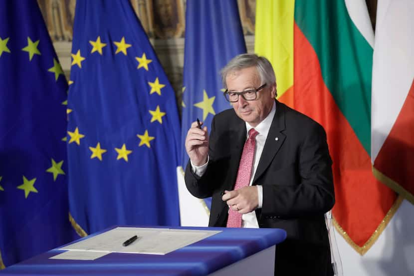 European Commission President Jean-Claude Juncker signs a declaration during an EU summit...